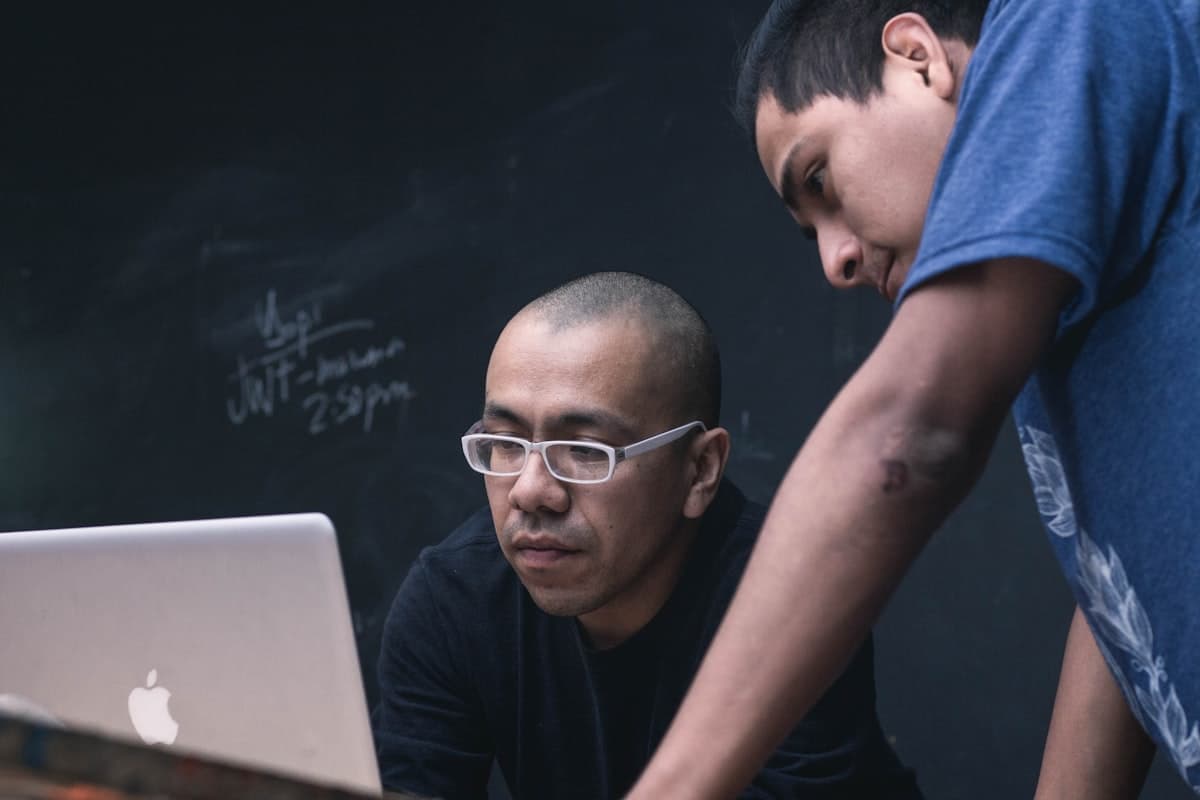 Tutor and student reviewing a lesson together on a laptop